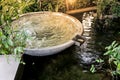 Circle shape water fountain and water fall in garden or park. Royalty Free Stock Photo