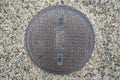 Circle steel manhole cover or metal sewer on the street in Japan