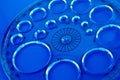 A plastic circles geometry tool on blue. Royalty Free Stock Photo