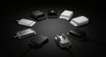 A circle of various external hard drives or charging devices is displayed on a dark Royalty Free Stock Photo