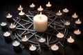 circle of white candles surrounding a silver pentacle