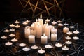 circle of white candles surrounding a silver pentacle