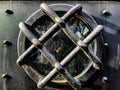 Circle window behind the black iron bars on the door to castle, Pezinok, Slovakia Royalty Free Stock Photo