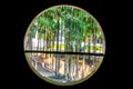 Circle window view of modern house with bamboo forest and natural sun lights and environment background Royalty Free Stock Photo