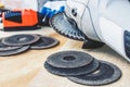 Circles for the angle grinder are on wooden boards near the grinder