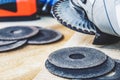 Circles for the angle grinder are on wooden boards near the grinder