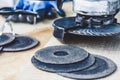 Circles for the angle grinder are on wooden boards near the grinder