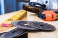 Circles for the angle grinder are on wooden boards near the grinder