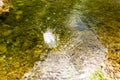 Circles on the surface of water with stones on the bottom