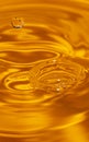 Circles on the water from a fallen drop of water. Yellow, golden background. Royalty Free Stock Photo