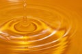 Circles on the water from a fallen drop of water. Yellow, golden background. Royalty Free Stock Photo