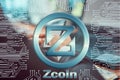 Circuit board on background of man working at laptop and holding smartphone in his hands. zcoin cryptocurrency symbol. Digital