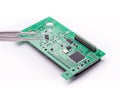 Circuit board with tweezers Royalty Free Stock Photo