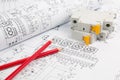 Circuit breaker and pencils on paper electrical engineering drawings Royalty Free Stock Photo