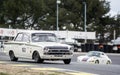 Ford Lotus Cortina being chased by a Porsche 911 in a classic car race at the Jarama circuit