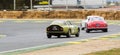 Green Alfa Romeo TZ1 chasing a Ferrari 250 GT berlinetta in a classic car race at the Jarama circuit