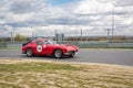 Red Ferrari 250 GT Berlinetta overtaking another black in a classic car race at the Jarama circuit