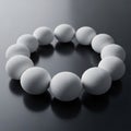 Of twelve smooth white spheres displayed on a reflective dark Royalty Free Stock Photo
