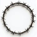 A close up of a circular barbed wire crown on a white background with sharp spikes all around it Royalty Free Stock Photo