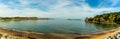 The circular bay of Lydstep Haven, Wales with Caldey Island in the distance Royalty Free Stock Photo