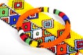 Circular Beaded Zulu Armband Atop Two Wristbands