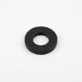 Circular black rubber washer on a plain white background. It features a central hole, Royalty Free Stock Photo