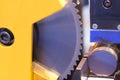 The circular blade saw machine cutting the metal rod.