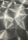 Circular brushed metal patterns cover a surface, creating a reflective effect. Each circle Royalty Free Stock Photo