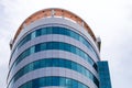 Circular building with lots of blue glass.