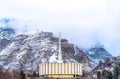 Circular church on a scenic landscape of snowy mountain and cloudy sky in winter Royalty Free Stock Photo