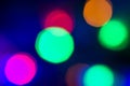 Circular colored bokeh over dark background