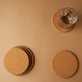 Circular cork coasters are arranged on a brown surface. A stack of three coasters is Royalty Free Stock Photo