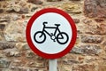 Circular cycling sign with bicycle icon with old stone wall background Royalty Free Stock Photo