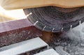 The circular diamond saw cuts concrete paving slabs. Concrete cutting machine close-up