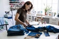 Circular economy. Sustainable fashion. Reuse, repair, upcycle. Denim upcycling ideas, repair and using old jeans. Woman Royalty Free Stock Photo