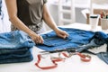 Circular economy. Sustainable fashion. Reuse, repair, upcycle. Denim upcycling ideas, repair and using old jeans. Woman Royalty Free Stock Photo