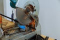 Circular electro saw cutting iron steel railings fence by with sparks