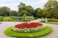 Circular flower bed with begonias in a landscaped garden. Royalty Free Stock Photo