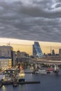 Circular highway leading to the Rainbow Bridge with Cargo and cruise ships moored or sailing in Odaiba Bay of Tokyo