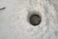 Circular hole drilled through the ice for fishing