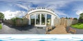 a circular house with glass windows and a wooden deck Royalty Free Stock Photo