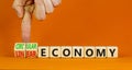 Circular or linear economy symbol. Concept words Circular economy or Linear economy on blocks. Beautiful orange background.