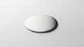 A circular metallic disc placed on a smooth light colored surface Royalty Free Stock Photo