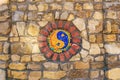 Mosaic symbol of Yin and yang on stone wall Royalty Free Stock Photo