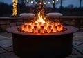 A circular outdoor fire pit with corn-shaped logs glowing brightly, Royalty Free Stock Photo