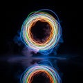 A circular pattern of colorful light trails, including blue, green, yellow, and orange, forms Royalty Free Stock Photo