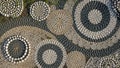 Circular patterns made from arranged pebbles in different shades of Royalty Free Stock Photo