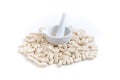 Pile of white tablets with a mortar and pestle