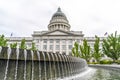 Circular pool and fountain with Utah State Capital dome and pedimented building