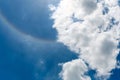 Circular rainbow surround the sun on blue sky with clouds. Sun haloÃ¢â¬â¹ phenomenon Royalty Free Stock Photo